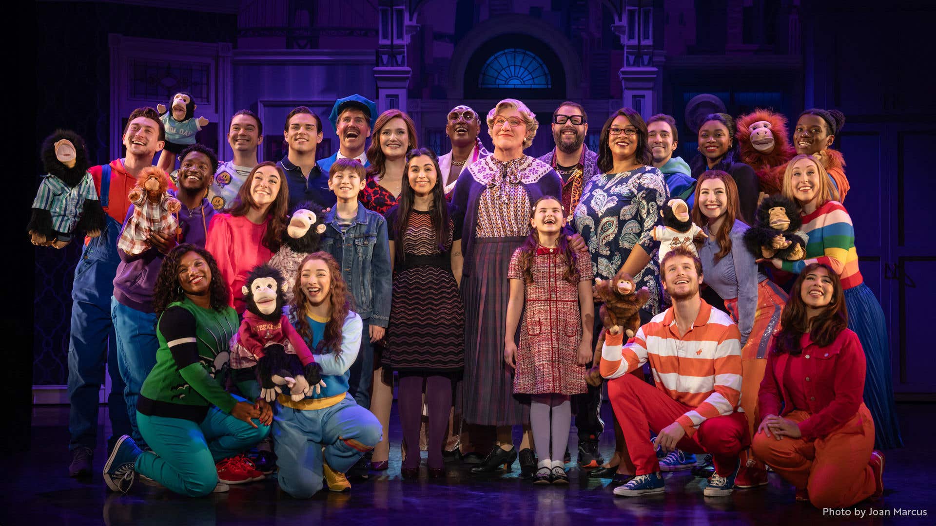 The entire cast of Mrs. Doubtfire on stage staring out at the camera. 